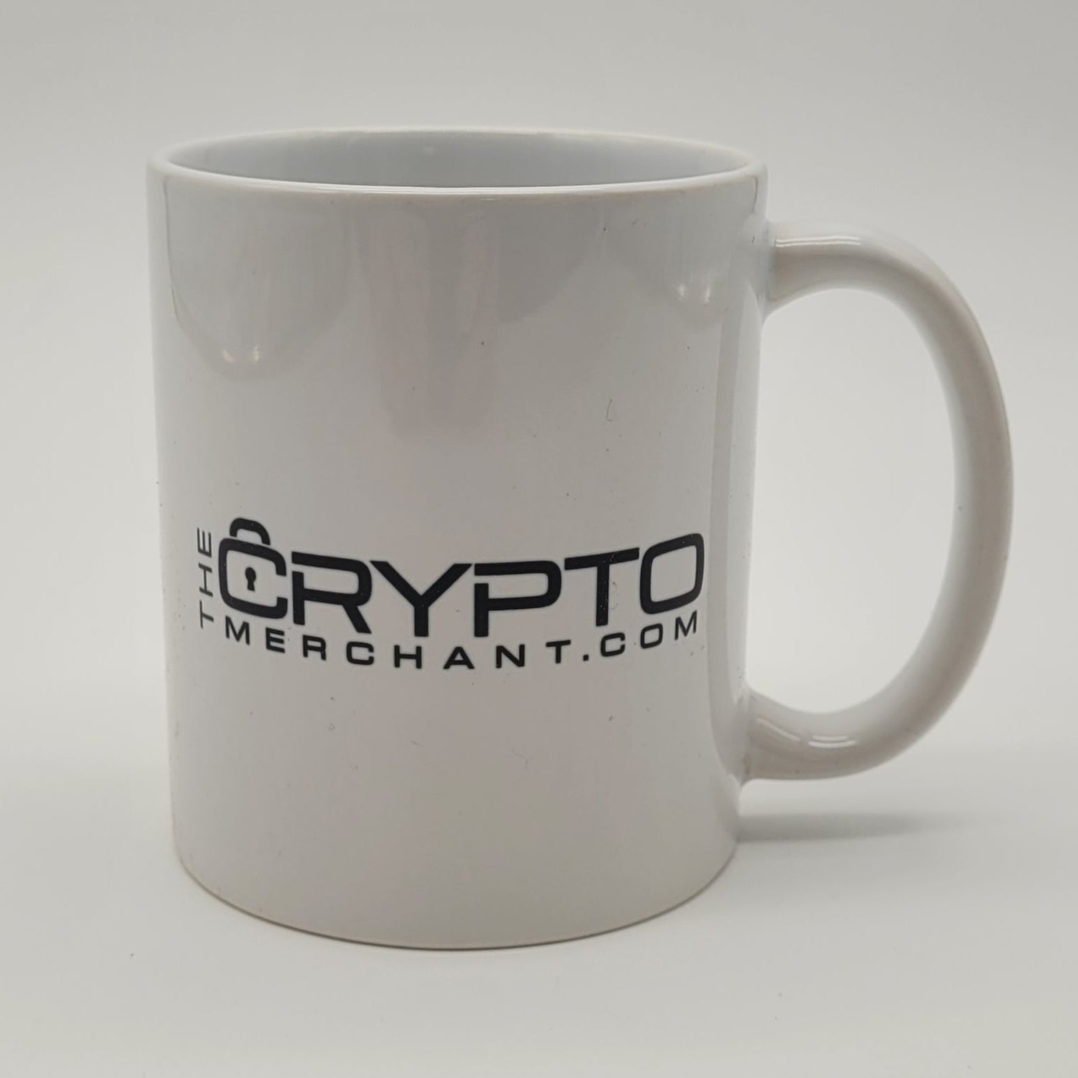 White mug with 'Crypto' branding on a light gray background