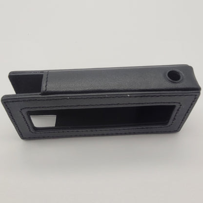 Black rectangular object with a slot on a white background